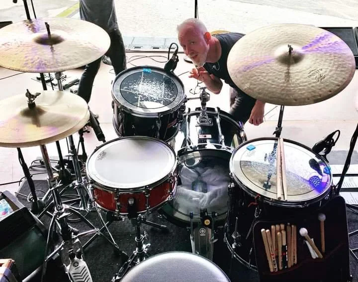 Aaron Comess' kit set up with the River Red Gum snare, Chris Barron peeking